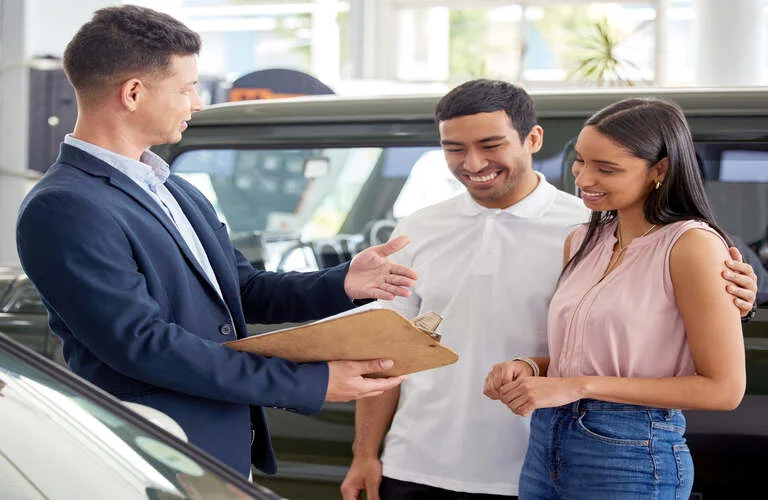 shot-of-a-car-salesman-assisting-a-young-couple-on-2023-11-27-04-56-37-utc (1)